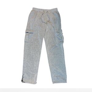 Grey uncuffed cargo sweatpants with a relaxed baggy fit and a streetwear vibe.